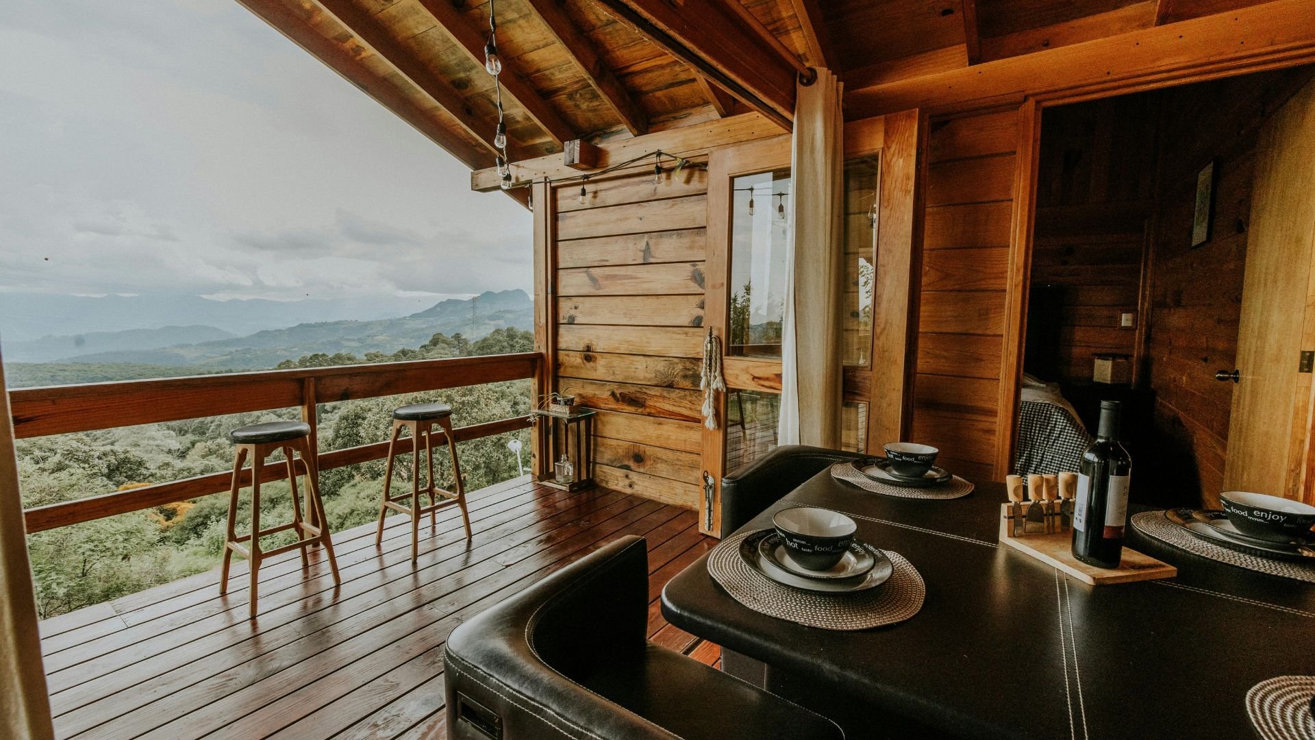 Wooden cabin dining area with mountain view and scenic balcony